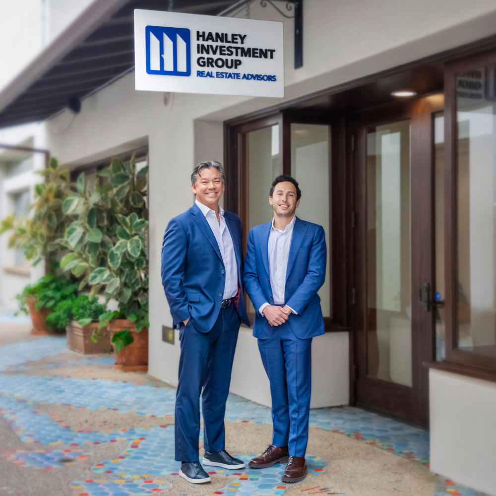 Ed Hanley and new partner Jeff Lefko pose in front of Hanley investment group